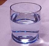 A cylindrical glass of clear liquid water